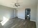 Bright bedroom with modern ceiling fan, light gray walls, and luxury vinyl plank flooring at 6360 Montclair St, Pahrump, NV 89061