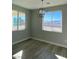 Well-lit dining area featuring large windows and modern chandelier lighting at 6360 Montclair St, Pahrump, NV 89061