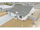 Overhead shot reveals a modern home with a three-car garage, new driveway, and tidy xeriscaping against desert backdrop at 6360 Montclair St, Pahrump, NV 89061