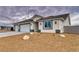 Street view of a new construction home featuring a three car garage and desert landscaping at 6360 Montclair St, Pahrump, NV 89061