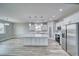 Spacious kitchen with a center island, modern pendant lighting, and stainless steel appliances at 6360 Montclair St, Pahrump, NV 89061