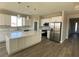 Bright kitchen featuring white cabinetry, stainless steel appliances, and a large island with a quartz countertop at 6360 Montclair St, Pahrump, NV 89061