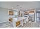 Bright kitchen with white cabinets, stainless appliances, quartz counters, and open shelving at 6360 Montclair St, Pahrump, NV 89061