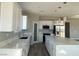 Bright kitchen featuring white cabinetry, stainless steel appliances, and a large island with a quartz countertop at 6360 Montclair St, Pahrump, NV 89061