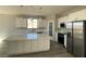 Modern kitchen featuring white cabinets, stainless steel appliances, and a large island with marble countertops at 6360 Montclair St, Pahrump, NV 89061