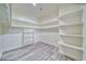 Bright walk-in closet featuring wood-look flooring and multiple levels of shelving at 6360 Montclair St, Pahrump, NV 89061