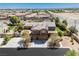 Aerial view of a landscaped property with solar panels, green lawns, and a three-car garage at 6391 Tempting Choice Ave, Las Vegas, NV 89131