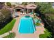 Aerial view of a backyard showcasing a pool with a spa, patio furniture, and manicured landscaping at 6391 Tempting Choice Ave, Las Vegas, NV 89131