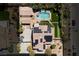 Aerial view of a desert home with a private pool, putting green and solar panels at 6391 Tempting Choice Ave, Las Vegas, NV 89131