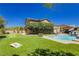 Landscaped backyard featuring a pool, a well-manicured lawn, outdoor lighting, and mature landscaping at 6391 Tempting Choice Ave, Las Vegas, NV 89131