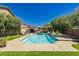 Expansive backyard with a pool, patio, lush landscaping, and an outdoor living space at 6391 Tempting Choice Ave, Las Vegas, NV 89131