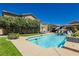 Backyard featuring a sparkling pool with tile surround, lounge seating, and an umbrella for shade at 6391 Tempting Choice Ave, Las Vegas, NV 89131