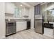 Well-equipped bar area featuring a wine cooler, mini-fridge, and ample counter space with backyard views at 6391 Tempting Choice Ave, Las Vegas, NV 89131