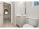 Bright bathroom featuring a toilet, vanity with storage, and tile floors at 6391 Tempting Choice Ave, Las Vegas, NV 89131