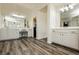 Spacious primary bathroom featuring double sinks, vanity, walk-in shower, and wood-look floors at 6391 Tempting Choice Ave, Las Vegas, NV 89131