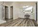 Bathroom featuring vanity, stall shower, walk-in closet, wood-look flooring, and great natural light at 6391 Tempting Choice Ave, Las Vegas, NV 89131