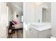 Bathroom features modern vessel sink next to bedroom with shutters and a cuckoo clock at 6391 Tempting Choice Ave, Las Vegas, NV 89131