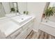 Modern bathroom featuring a rectangular sink, white cabinetry, and a large mirror at 6391 Tempting Choice Ave, Las Vegas, NV 89131