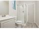 Well-lit bathroom with a modern glass-enclosed shower, neutral paint and tiled floor at 6391 Tempting Choice Ave, Las Vegas, NV 89131