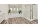 Elegant bathroom featuring a soaking tub, glass shower, and plenty of natural light at 6391 Tempting Choice Ave, Las Vegas, NV 89131