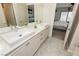 Bright bathroom featuring a double sink vanity with modern fixtures and tile flooring at 6391 Tempting Choice Ave, Las Vegas, NV 89131