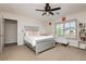 Comfortable bedroom with a ceiling fan, carpet flooring, and natural light at 6391 Tempting Choice Ave, Las Vegas, NV 89131