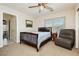 Cozy bedroom with a wood bed frame, carpet, and adjacent bathroom at 6391 Tempting Choice Ave, Las Vegas, NV 89131