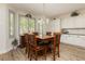 Bright dining area with natural light, modern chandelier, and cabinetry at 6391 Tempting Choice Ave, Las Vegas, NV 89131