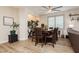 Cozy dining room with a large window, modern lighting, and a seating arrangement for eight at 6391 Tempting Choice Ave, Las Vegas, NV 89131