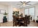 Formal dining room featuring wood floors, a modern ceiling fan, and ample lighting at 6391 Tempting Choice Ave, Las Vegas, NV 89131