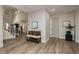 Inviting entryway featuring wood flooring, a bench with pillows, and staircase at 6391 Tempting Choice Ave, Las Vegas, NV 89131