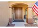 Inviting covered front porch featuring a double door entry and a welcome sign at 6391 Tempting Choice Ave, Las Vegas, NV 89131
