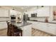 Modern kitchen featuring stainless steel appliances, granite countertops, and a stylish center island at 6391 Tempting Choice Ave, Las Vegas, NV 89131