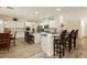 Spacious kitchen with white cabinets, granite countertops, and a large island with bar seating at 6391 Tempting Choice Ave, Las Vegas, NV 89131