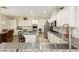 Bright kitchen with white cabinets, granite countertops, a center island, and stainless steel appliances at 6391 Tempting Choice Ave, Las Vegas, NV 89131