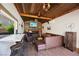 Inviting living room with a wood-beam ceiling, stone fireplace and full bar for entertaining at 6391 Tempting Choice Ave, Las Vegas, NV 89131