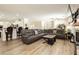 Open-concept living room with hardwood floors, fireplace, and plenty of natural light at 6391 Tempting Choice Ave, Las Vegas, NV 89131