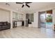 Bright living room featuring a wet bar, stainless steel appliances, wood flooring, and sliding glass doors to the pool at 6391 Tempting Choice Ave, Las Vegas, NV 89131