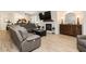 Comfortable living room with a fireplace, large television, and gray leather seating at 6391 Tempting Choice Ave, Las Vegas, NV 89131