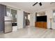 Bright living room featuring wood flooring, neutral paint, stainless steel refrigerator, and backyard access at 6391 Tempting Choice Ave, Las Vegas, NV 89131