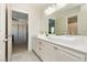 Bright primary bathroom featuring double sinks, white cabinetry, and tile flooring at 6391 Tempting Choice Ave, Las Vegas, NV 89131