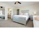 Bright primary bedroom with a silver bed frame, sofa, and access to the bathroom at 6391 Tempting Choice Ave, Las Vegas, NV 89131