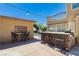 Outdoor living area with a bar, seating, and string lights, perfect for entertaining at 6391 Tempting Choice Ave, Las Vegas, NV 89131