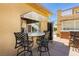 Outdoor bar boasts granite countertop, seating, and convenient pass-through window to the kitchen at 6391 Tempting Choice Ave, Las Vegas, NV 89131