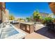 Outdoor kitchen featuring a sink, grill, counter space, and a dining area at 6391 Tempting Choice Ave, Las Vegas, NV 89131