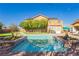 Inviting backyard featuring a refreshing pool, lush greenery, and an outdoor dining area for entertaining at 6391 Tempting Choice Ave, Las Vegas, NV 89131