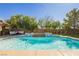 Relaxing pool featuring decorative water features, lush landscaping, and outdoor furniture at 6391 Tempting Choice Ave, Las Vegas, NV 89131