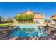 Outdoor pool area with a spa, tanning chairs, and an adjacent building at 6391 Tempting Choice Ave, Las Vegas, NV 89131
