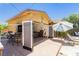 Charming pool house with seating, a bar, and open doors to the backyard at 6391 Tempting Choice Ave, Las Vegas, NV 89131
