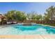 Backyard pool and spa area surrounded by mature trees offer a peaceful setting at 6391 Tempting Choice Ave, Las Vegas, NV 89131